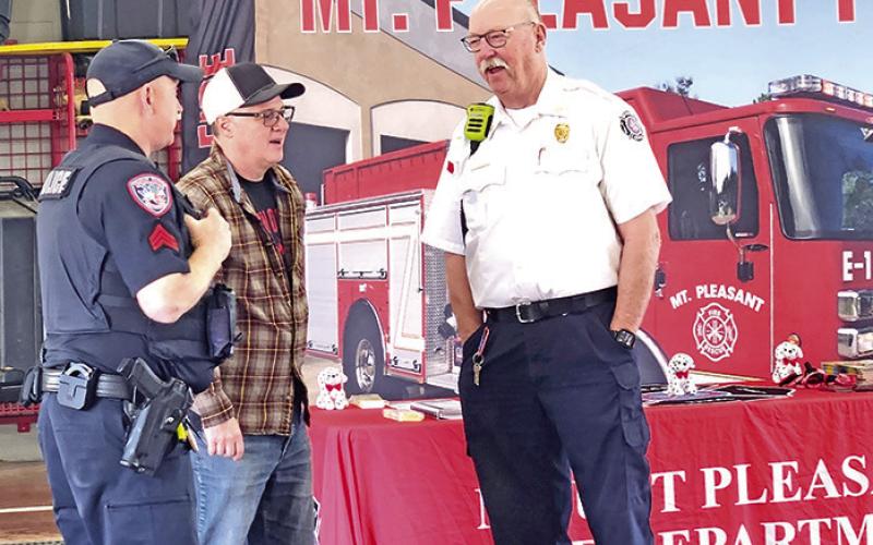 Mt. Pleasant fire chief and police chief visit during the free pancake breakfast TRIBUNE PHOTO / NICOLE KIMBALL