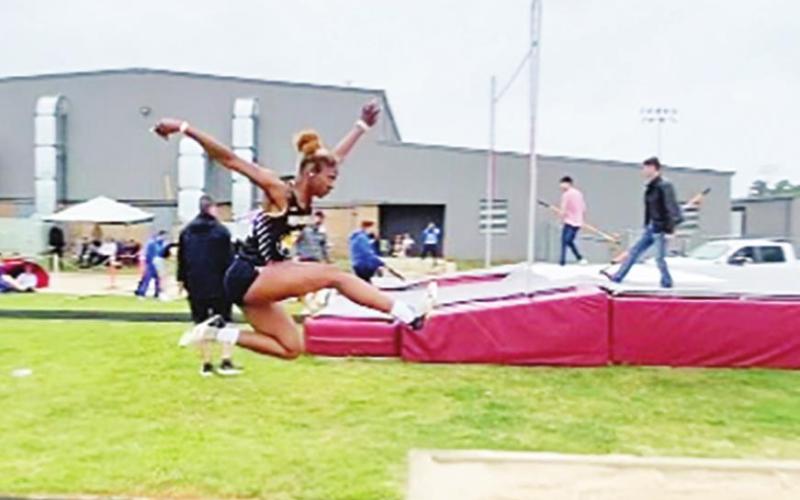 Ladi Guereca flies into the pit during long jump.