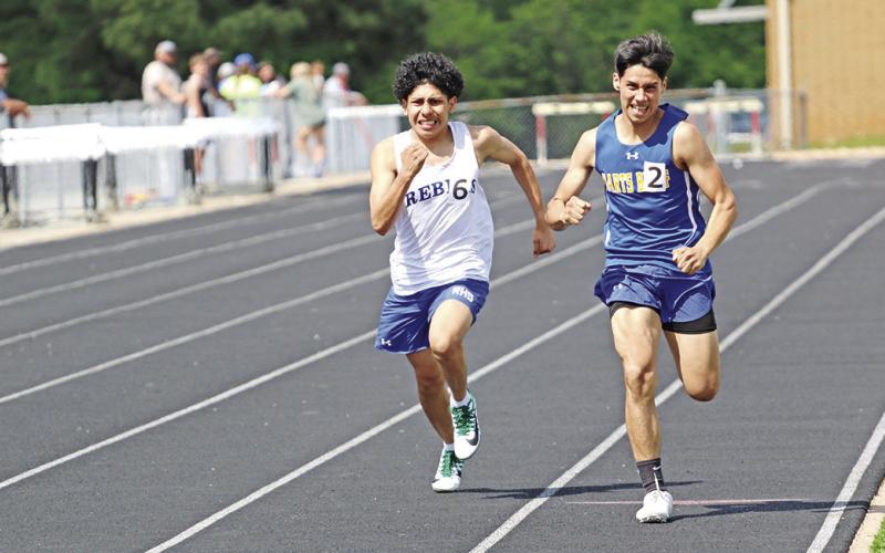 Rivercrest’s Joseph Roquez and Harts Bluff’s Johnathan Diaz race to the finish line during the varsity boys’ 800 meter run Wednesday afternoon. Both will advance to the area track meet; Roquez finished second and Diaz finished third.