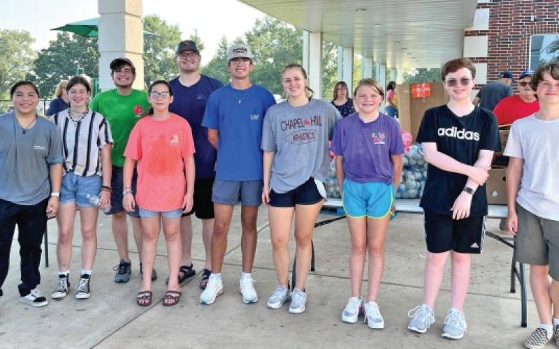 FBC youth lends a hand at TCC produce drop