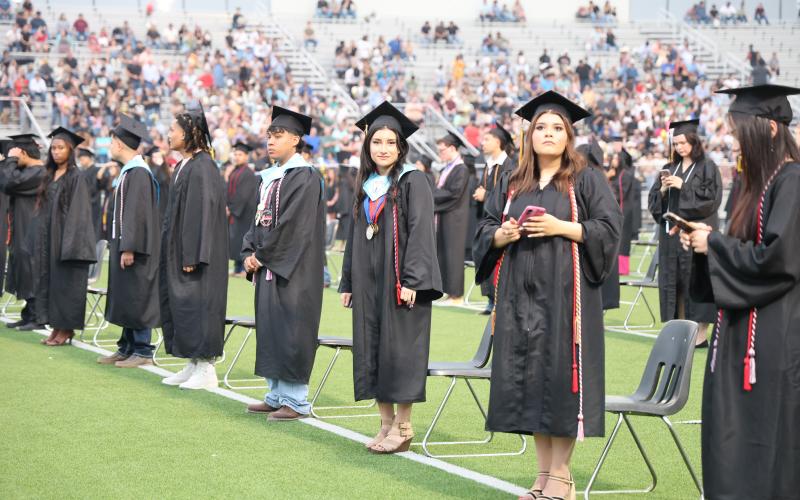 Graduates happily standing during their ceremony