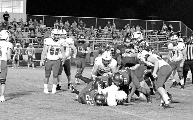 From left, Rivercrest’s Dalton Lovett (#22), Ethan Taylor (#53) and JaQuan Brown (#33) wrestle down a ball carrier during a recent game. The Rebels will celebrate Homecoming Friday during their district opener against Como-Pickton. TRIBUNE PHOTO / QUINTEN BOYD