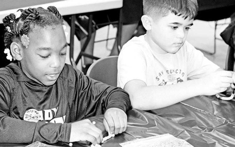 Corprew Ja’Veona Nixon and Charles Johnson: Fourth grade students Ja’Veona Nixon and Charles Johnson from Corprew make UV detection bracelets
