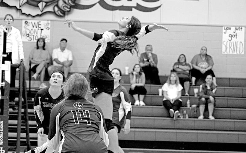 Harts Bluff’s Alexis Gonzalez jumps for a spike as teammates Ally Cook (foreground), Kaitley Green (background, left) and Allie Mayfield (background, right) look on. The Lady Bulldogs split their two games last week. TRIBUNE PHOTO / QUINTEN BOYD