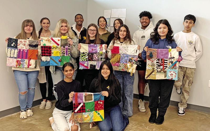 MPHS Fashion Design students show some of the fidget blankets they have created so far. Back row L to R: Jordyn Warren, Emily Shelton, Faith Rothrock, Skyler Guereca, Zoey Cato, Melissa Carralero, Jillian Jetton, Daniela Pina, Adrian Brooks, Perla Ferretiz, Emerson Castillo. Front row L to R: Sendy Sandoval, Lizeth Quistan.