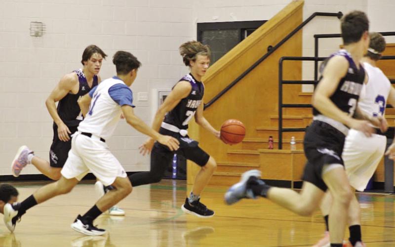 CHAAMP guard John Luke Angier pushes the ball up the court for a fastbreak after stealing the ball. Angier finished the game with a team high 10 steals. COURTESY PHOTO
