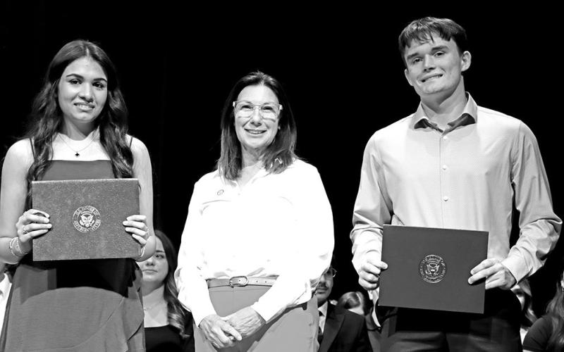 Diya Desai (left) and Tanner Marshall (right) accept the Texas First Congressional Service Awards from Robbin Bass COURTESY PHOTO
