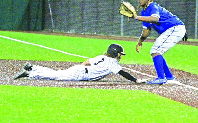 Mount Pleasant’s Christian Johnson slides back to first base as Tyler’s Tory Howland awaits the throw. The Tigers won over the Lions, 7-1. TRIBUNE PHOTO / QUINTEN BOYD