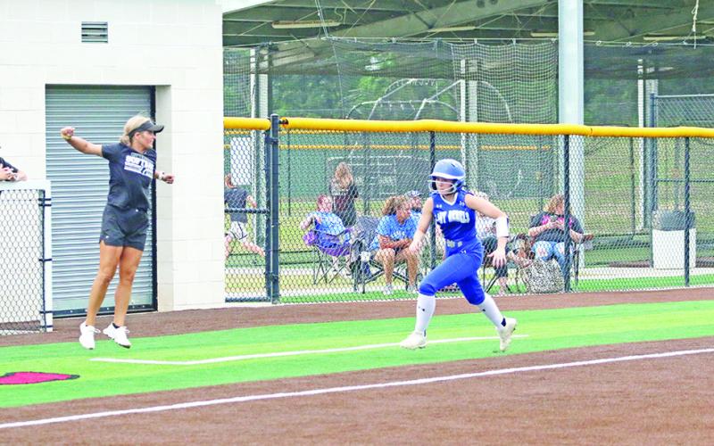 Rivercrest head coach Kara Crawford waves home Madison Tippit after an RBI hit by Lakin Mankins during game two. The Lady Rebels fell to Frankston in the best of three series, 2-0. TRIBUNE PHOTOS / QUINTEN BOYD