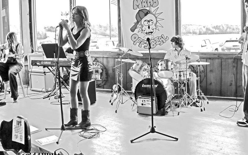 Cover band MADD Official, a group of kids from Chapel Hill ISD, performs an array of rock songs at Big Al’s Barefoot Bay on Feb. 15. (From left to right) guitarist Claire Kastan, lead singer Ayva Morin, (behind Morin) special guest pianist David Sekulic, drummer Drew Mays and bassist Atticus Day-Alleman. Photo by Lexi DeLaRosa