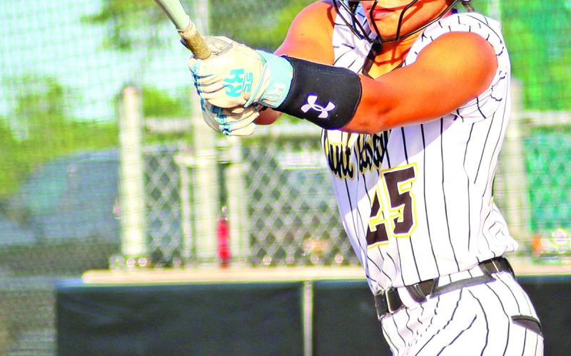 Kaylin Brannon slaps for a single against Hallsville. Brannon broke the record for the most hits during a single season on Friday.