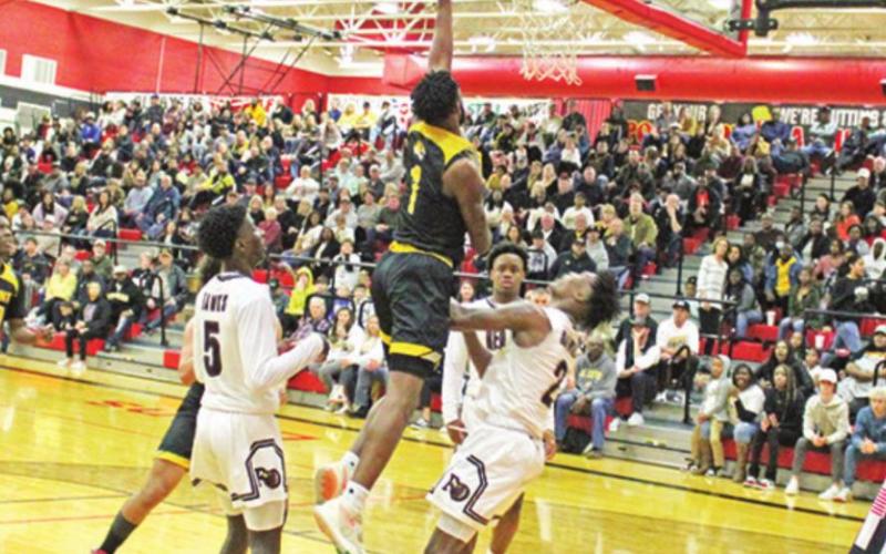 Mount Pleasant’s Will Hills drives for a layup during Saturday’s area round game. TRIBUNE PHOTO / QUINTEN BOYD