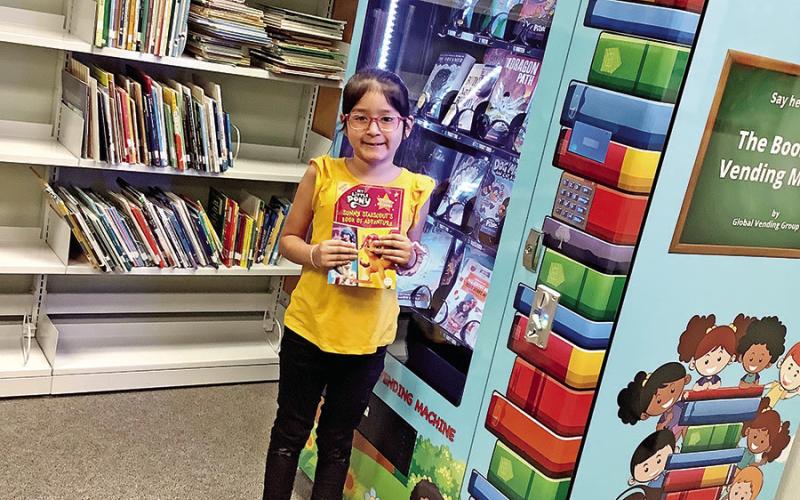 First-grader Valarie Gonzalez selects a My Little Pony book