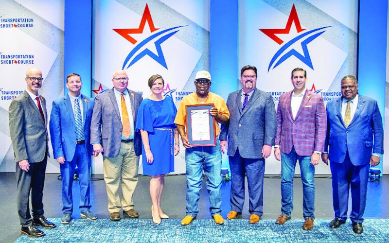 From left: TxDOT Executive Director Marc Williams, TxDOT Chief Engineer Lance Simmons, TxDOT Deputy Executive Directors Brian Barth &amp;amp; Brandye Hendrickson, Extra Mile Award recipient Elton Bolden, Texas Transportation Commissioner W. Alvin New, Texas Transportation Commissioner Alejandro “Alex” G. Meade III and Texas A&amp;amp;M Board of Regents Chairman Bill Mahomes COURTESY PHOTOS