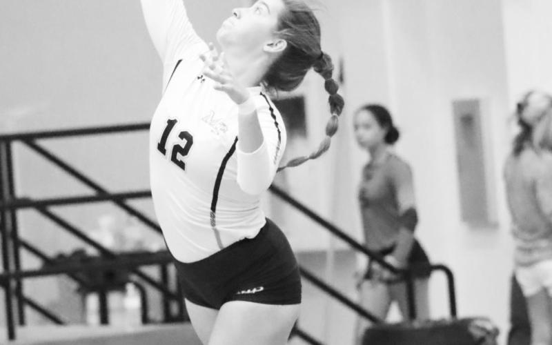 Senior Hadleigh Mays serves the ball. COURTESY PHOTO / JOHN WHITTEN
