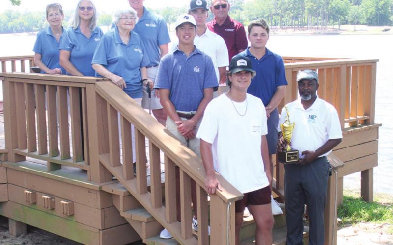 Mount Pleasant Mayor Tracy Craig presents the Mayor’s Cup trophy to the Sisk Motors team of Chandler Currey, Brady Sisk, Baker Peterson and Matthew Peterson, champions of the 32nd annual Mayor’s Cup golf tournament. In back are Jimmy Harbour and members of the board for Mount Pleasant Habitat for Humanity. The tournament raised funds for the organization. TRIBUNE PHOTO / QUINTEN BOYD