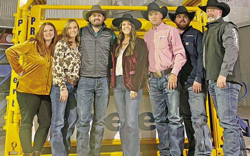 The Priefert Crew poses beside a bucking chute outside the Thomas and Mack Center as they prepare for NFR activities and competitions. COURTESY PHOTO
