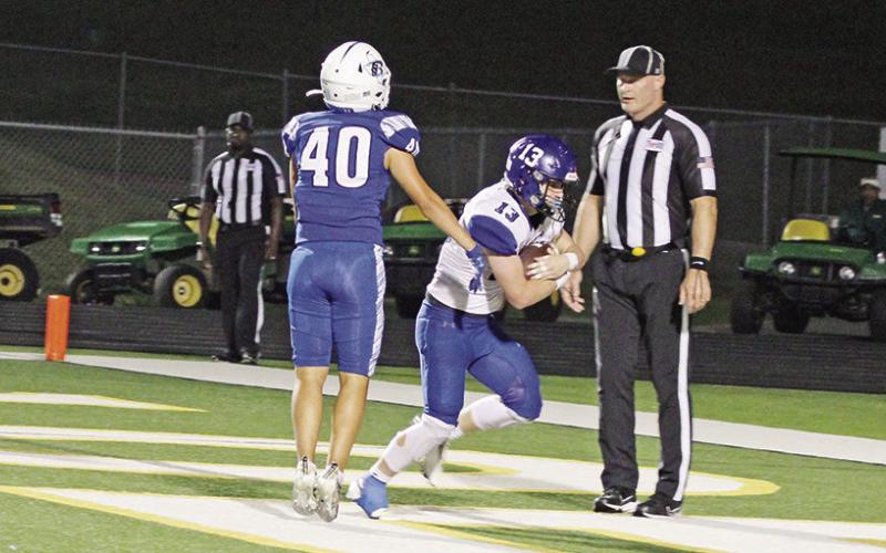 Zane Dees powers his way past Jordan Mojica for Rivercrest’s touchdown in their playoff game Thursday against Beckville at Longview’s Lobo Stadium. TRIBUNE PHOTO / QUINTEN BOYD