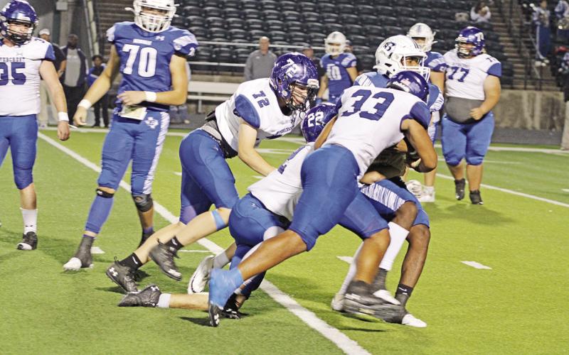 Rivercrest’s JaQuan Brown (#33), Dalton Lovett (#22) and Aaron Raulston (#72) combine to bring down Beckville’s Jorden Prince during Thursday’s game. TRIBUNE PHOTO / QUINTEN BOYD