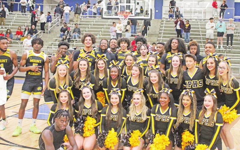 The Tiger basketball team and varsity cheerleaders pose following Mount Pleasant’s win that sends them to their fourth regional tournament in the last five years. TRIBUNE PHOTOS / QUINTEN BOYD