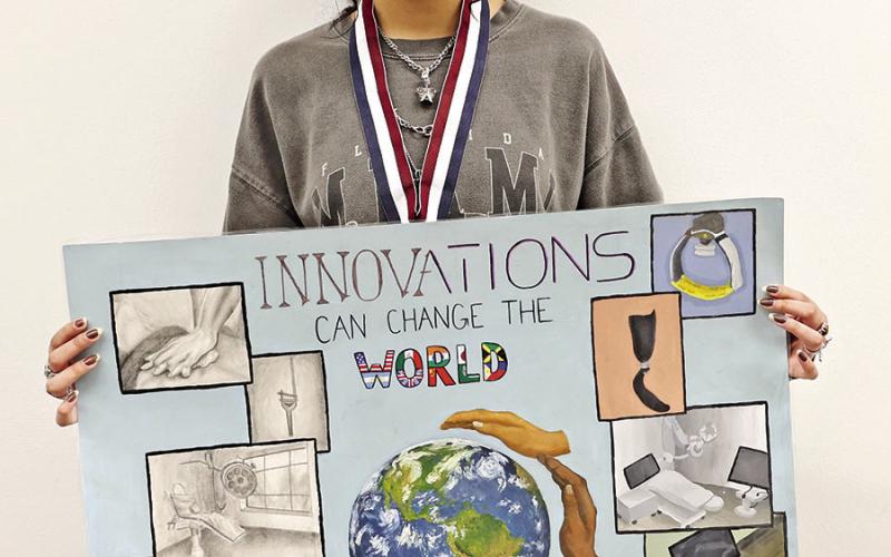 MPHS senior, Tisha Patel, with her state advancing Medical Art Poster COURTESY PHOTO
