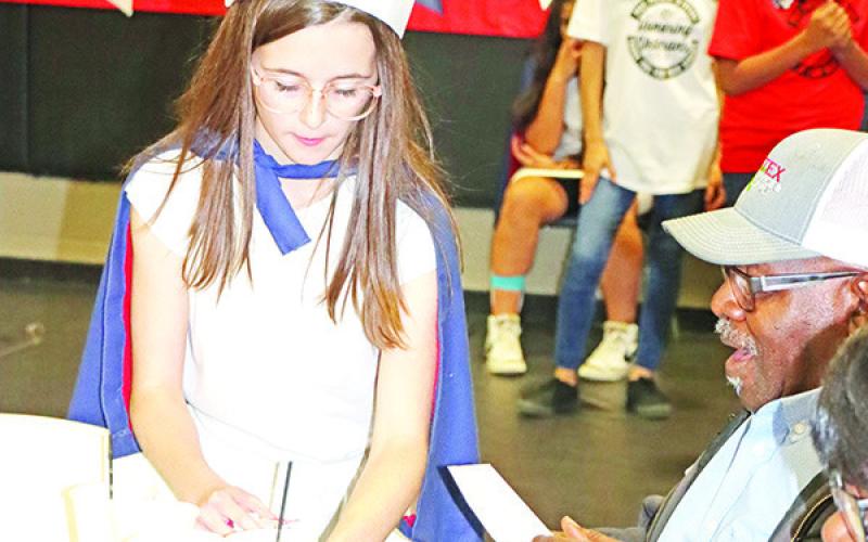 Wallace student, Sage Jordan, serves coffee to a veteran.