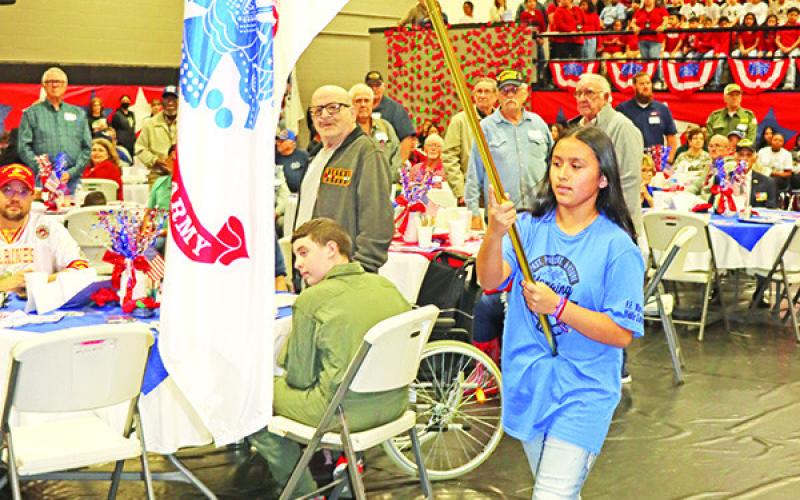 Wallace student, Michelle Hernandez, carries the Army flag.