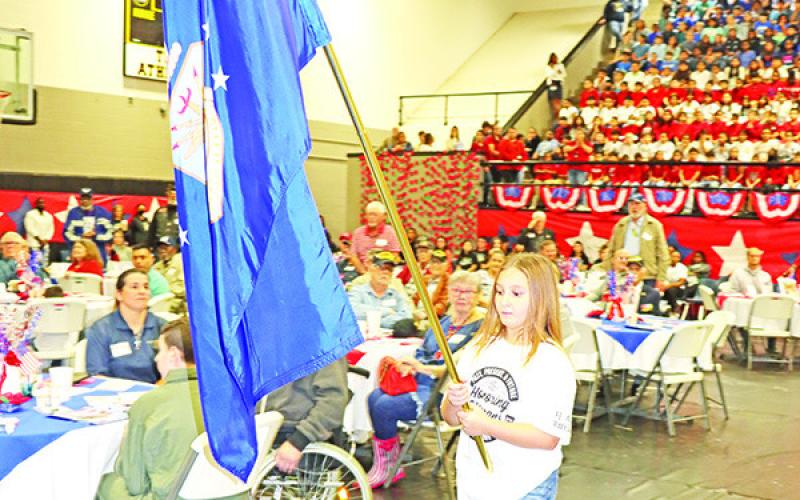 Wallace student, Abigail Verner, brings in the Air Force flag.