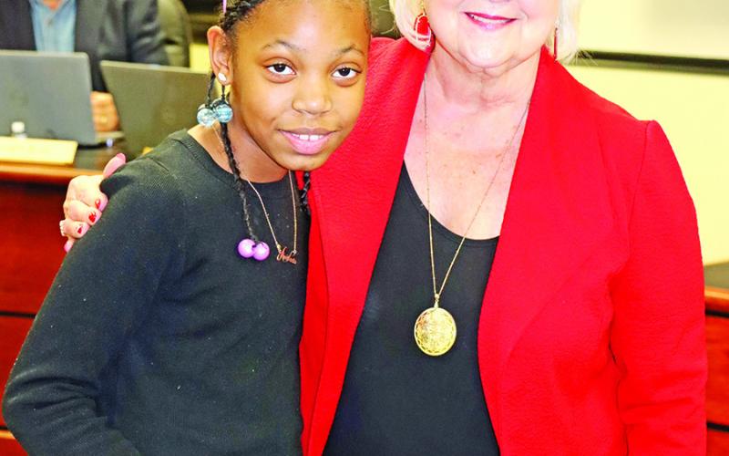 Corprew NEHS President Anastacia Davis (left) thanks Sandy Bible