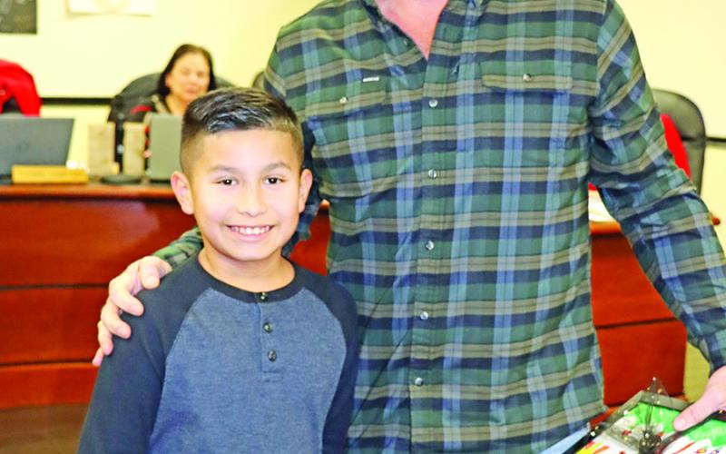 Sims NEHS President Aaron Garcia (left) recognizes Luke Anderson