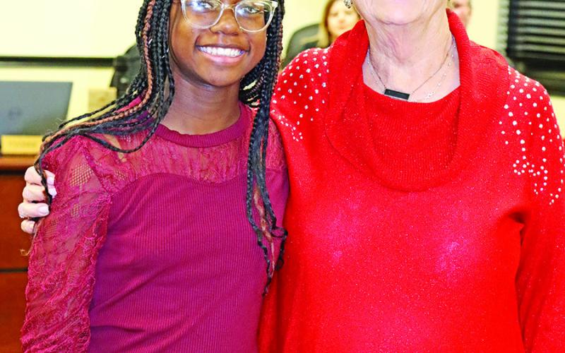 MPJH NJHS President Kennedy Jones (left) presents to Yvonne Hampton