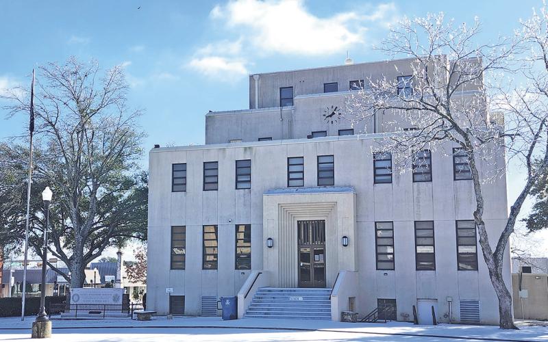 Titus County Courthouse surrounded by a layer of snow