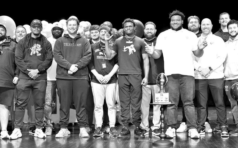 Deuce Thompson and Ayden Johnson with the MPHS football coaching staff Photos by John Whitten