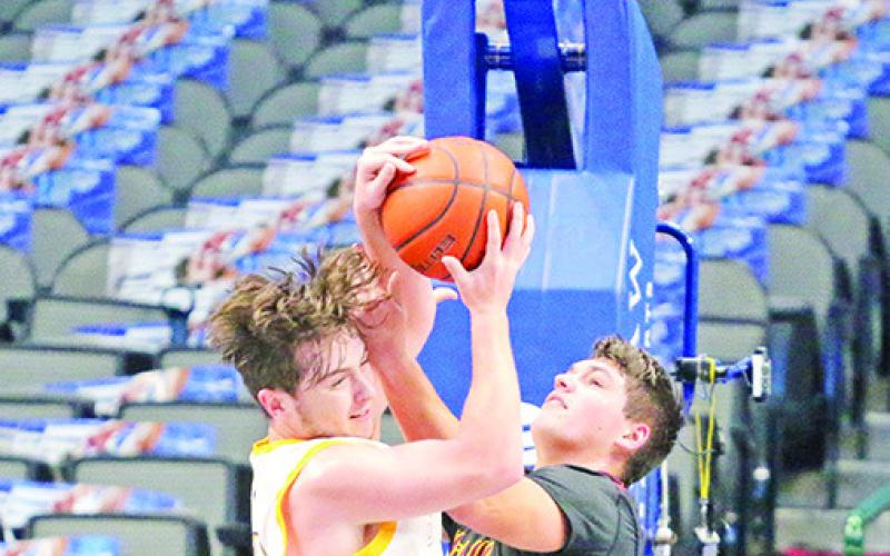Harts Bluff’s Hunter Green battles for a rebound during Wednesday’s Court of Dreams game at Dallas’ American Airlines Center. The Bulldogs fell just short against McLeod, 5352.