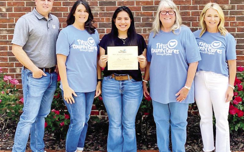 Titus County Cares awards Mrs. Beverly Eversole scholarships
