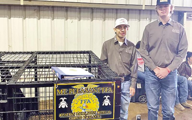 Aidyn Botello (left) and Jonathan Dalby with their hog trailer