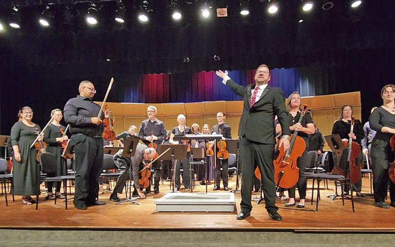 Music Director David Mills proudly presents the Mount Pleasant Community Orchestra for applause after the performance TRIBUNE PHOTO / NICOLE KIMBALL