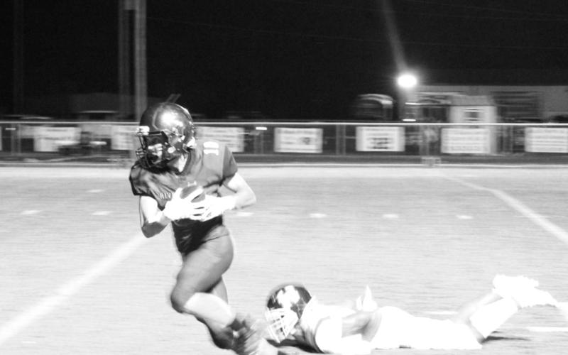 Rivercrest’s Connor Herring breaks away from a Harleton defender on his way to a 36-yard touchdown. The Rebels fell short against the Wildcats, 44-26. TRIBUNE PHOTO / QUINTEN BOYD