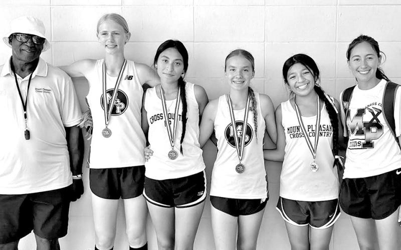 District medalists (L to R) Coach Jesse Morris, Mary Beth Snyder, Emelyn Gaona, Alexia Hawkins, Victoria Salmeron, Coach Martina Ramirez
