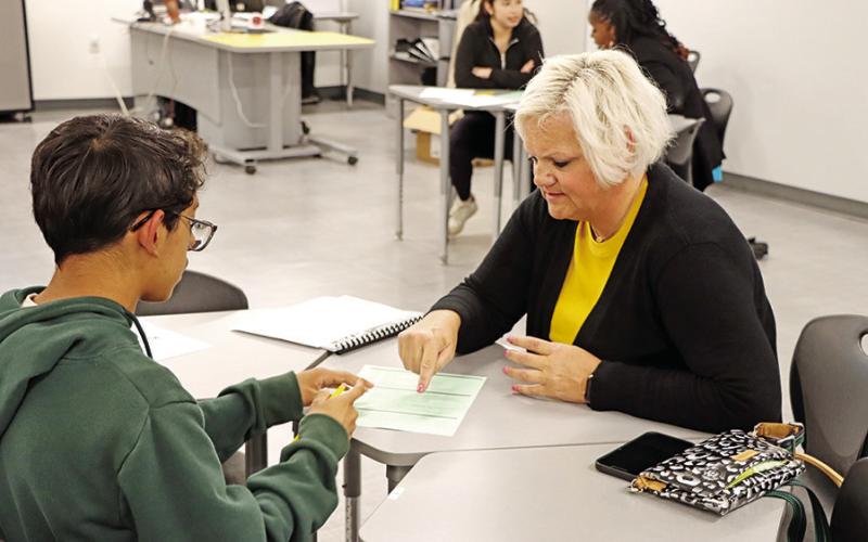 MPHS teacher, Misty McCrumby (right), helps a new student choose courses for his freshman year (COURTESY PHOTOS)