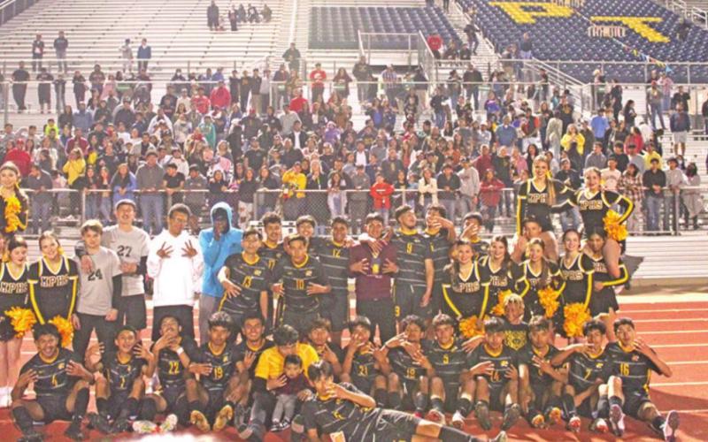 The Mount Pleasant soccer team celebrates with the fans and cheerleaders after their regional quarterfinal victory over Whitehouse Friday.