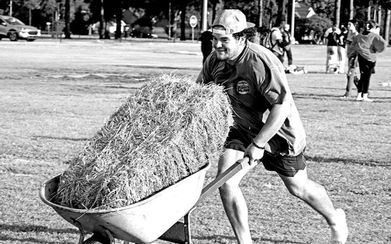 Corben Craig competes in the wheelbarrow relay