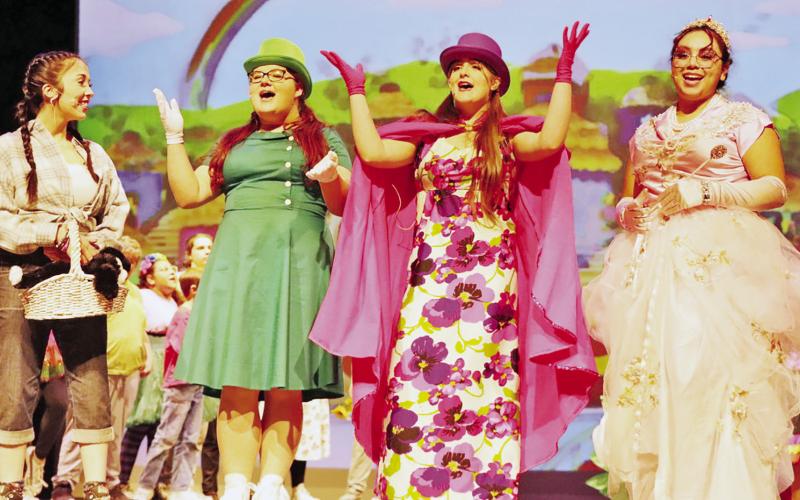 Dorothy (Madison Zepeda, left) is welcomed to Munchkin Land by (L to R) Ensemble member (Danika Beckham), Leader of the Winkie Guards (Emma Sanders) and Glinda the Good Witch (Gracie Martinez) COURTESY PHOTO