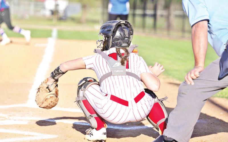 Hannah Rhea catches a pitch during Chapel Hill’s game against Quitman. The Lady Red Devils defeated the Lady Bulldogs, 3-1. COURTESY PHOTO
