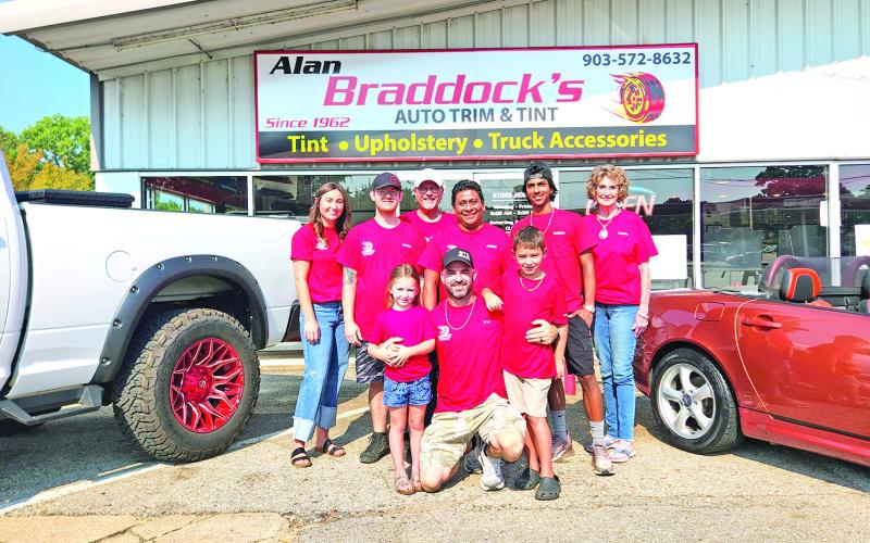 The Braddock’s family stands in front of their auto business of 63 years