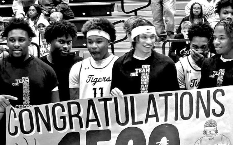 Carter Chism and teammates celebrate him reaching the 1500 point mark in his high school career.