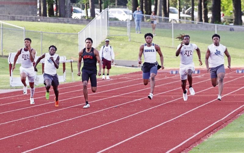 Pewitt’s James Byrd (far right) and Junie Johnson (second from left) battle during the varsity boys 100 meter finals at the District 14-3A Track Meet Thursday in Atlanta. Johnson finished second in the race and Byrd finished third, with both qualifying for the area meet. BEE PHOTO / QUINTEN BOYD