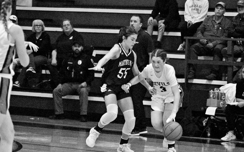 Chapel Hill’s Ellie Wooten drives against Martins Mill’s Kara Nixon during Tuesday’s game. The Lady Devils fell against the Lady Mustangs, 56-30, and will play at home Monday and Tuesday afternoon against New Boston and Douglass.