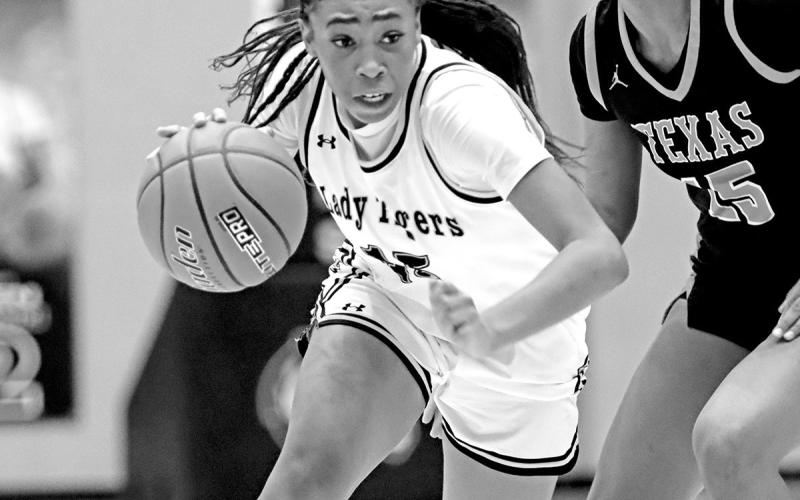 Shannon Hines attacks the paint against the Texas High Lady Tigers. Hines led Mt. Pleasant with 14 points.