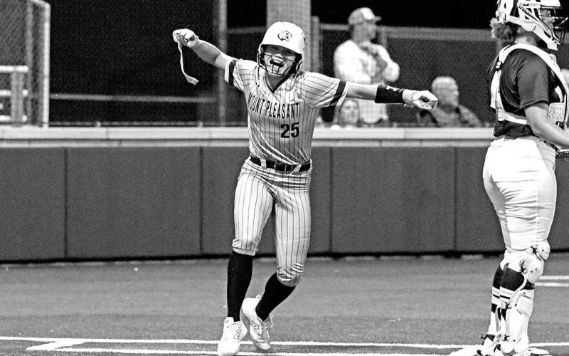 KK Brannon celebrates after connecting with the first pitch of the series and scoring on an inside the park homerun.